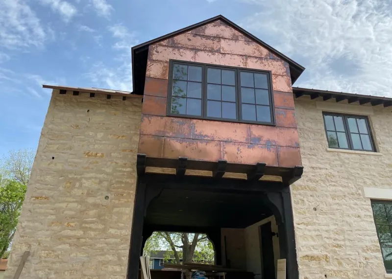 Copper metal panel facade on a stone building for Skylight Installation in Prattville