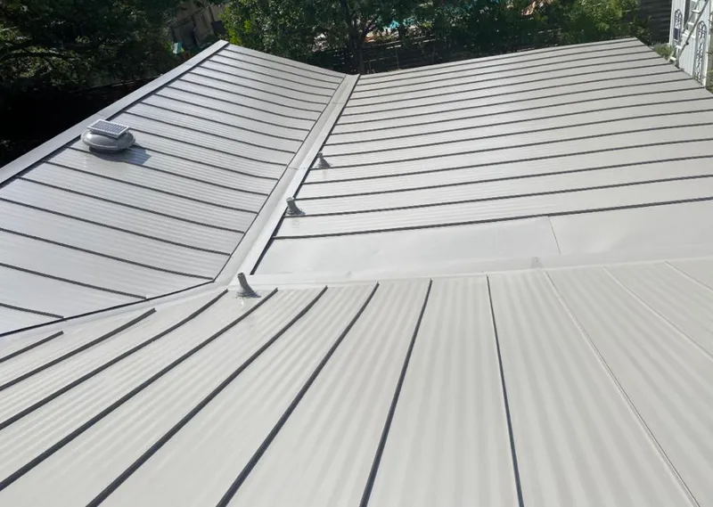 Solar attic fan installed on a metal roof for Roof Ventilation in Prattville